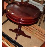 A Chinese circular hardwood occasional table, fitted two drawers, on tripod base, 21" dia