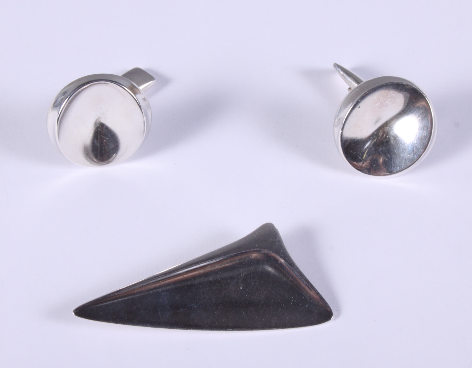 Henning Koppel for Georg Jensen, a silver brooch no 327, and a pair of Georg Jensen silver cufflinks