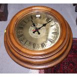 A battery powered wall clock, in oak case, 27" dia