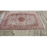 A Persian design rug with central anchor medallion and spandrels on an ivory floral ground, 66" x