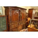 An early 18th century oak cupboard, the upper section enclosed two doors over three drawers with