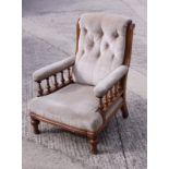 A Victorian armchair, upholstered in a beige velour, with spindle turned arm supports