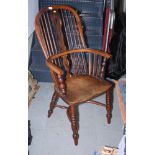 A 19th century yew Windsor armchair, the back decorated plain spindles and pierced central splat, on