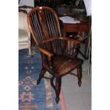 A 19th century yew Windsor armchair, the back decorated plain spindles and pierced central splat, on