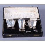 A silver three-piece cruet set, in fitted case