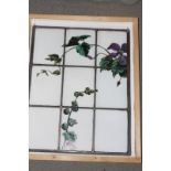 Eight late 19th century stained leaded glass panels with floral design, each 17" x 21" approx, and a