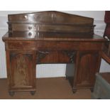 An early Victorian figured mahogany ledge back double pedestal sideboard, fitted three drawers