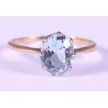 A yellow gold and aquamarine single stone dress ring, size L