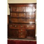 An 18th century oak dresser with boarded back fitted two shelves over base fitted six drawers and