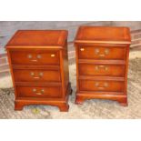 A pair of Georgian design yew three drawer bedside chests