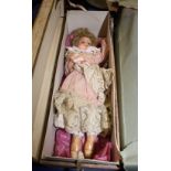 A Victorian wax head doll, in pink lace trimmed dress