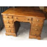 A waxed pine double pedestal desk, fitted nine drawers, 48" wide