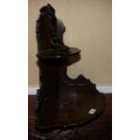 A stained as mahogany two-tier corner wall bracket