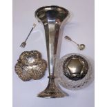 A silver topped cut glass scent bottle, a silver trumpet vase with weighted base, a silver bonbon