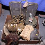 A brass bell, a 12 lb artillery shell base, a brass coal bucket, a set of brass fire implements, a
