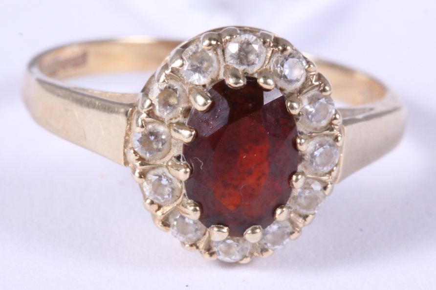 A 9ct yellow gold garnet and white sapphire cluster ring, size J