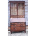A late 19th century mahogany and banded bureau bookcase, the upper section enclosed lattice glazed