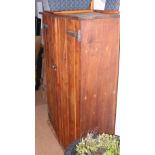A pine cupboard enclosed two doors with metal strap hinges, 40" wide