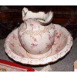A Victorian floral transfer decorated toilet jug and bowl and a wooden table lamp, carved man