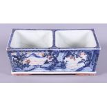 A late 19th century Chinese Imari two-section planter, decorated with a mountainous village scene,