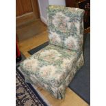 An Edwardian low reclining nursing chair, upholstered in a Gainsborough design fabric