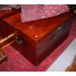 An Oriental mahogany blanket box with hinged cover, decorative brass lock plate and side carrying
