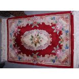 A pair of Chinese red and ivory coloured rugs, a similar rug and a Chinese celadon green floral