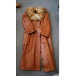 A Finnish tan leather and fox fur lined and collared full length coat