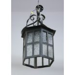 A wrought iron standard lamp, on splay support, a wrought iron ceiling lantern and two two-light