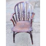 A 19th century Windsor target back armchair, on turned underframe with crinoline stretcher, two