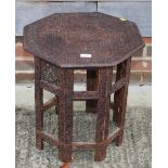A chip carved octagonal top table, on folding base, 18" wide