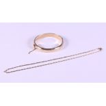 A 9ct gold hinged bangle with engraved decoration and a 9ct gold necklace, 25g