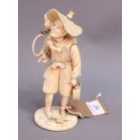 A 19th century sectional carved ivory figure of a fisherman with a monkey on his shoulder, 8" high