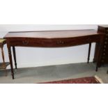A 19th century serpentine fronted mahogany serving table, fitted three drawers on turned supports,