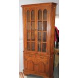 A Georgian design mahogany standing corner cabinet, the upper section enclosed by two glazed doors