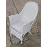 A white painted Lloyd Loom armchair with sprung seat