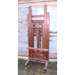 An artist's 19th century full-size studio easel with adjustable height width and angle, on