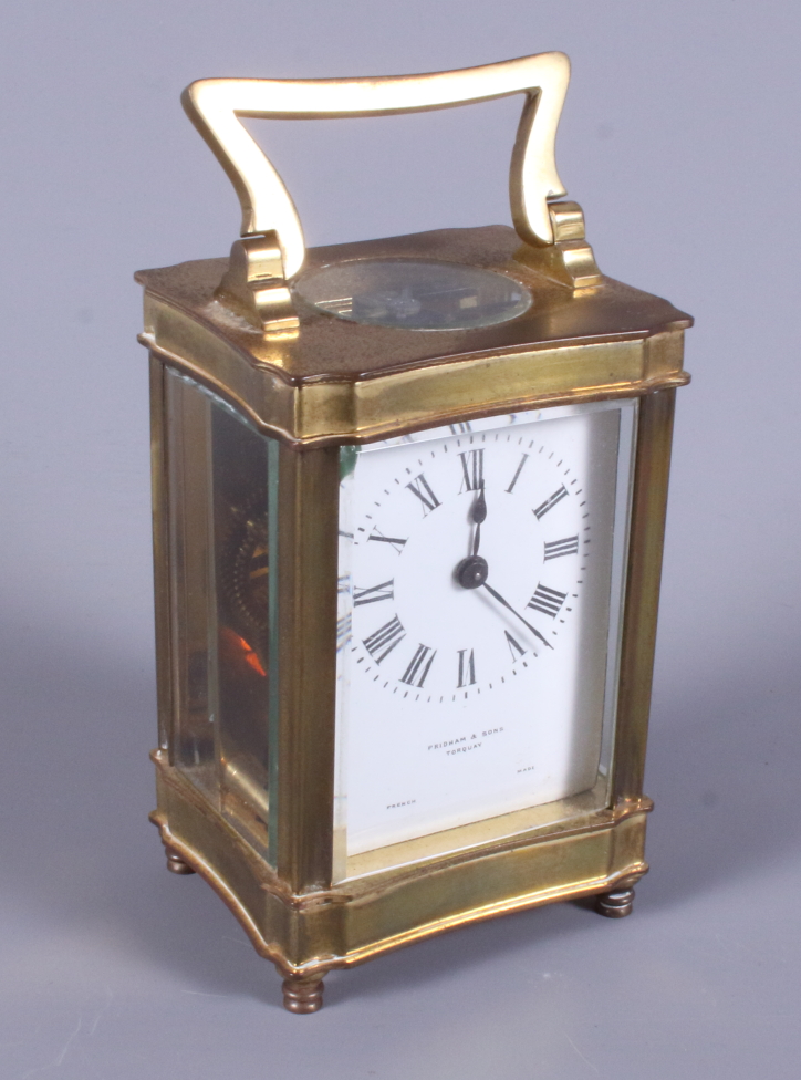 A French early 20th century brass carriage clock, retailed by Pridham & Sons, Torquay, with white