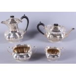 A four-piece silver teaset, comprising a teapot, a hot water pot, a two-handled sugar bowl and a