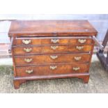 An early Georgian walnut and banded fold-over top chest of four long graduated drawers, on bracket