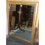 A bevel edged wall mirror, plate 27" x 39", in deep gilt frame