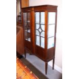 An Edwardian mahogany box and ebony strung break bowfront display cabinet enclosed two panelled