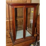 A 19th century mahogany table top display cabinet enclosed two sliding doors, 15" wide