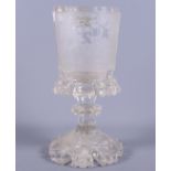 A 19th century clear glass vessel with an intricately engraved panel of deer in a wood