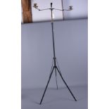 An early 20th century music stand with twin candle sconces, on tripod splay supports, 43" high