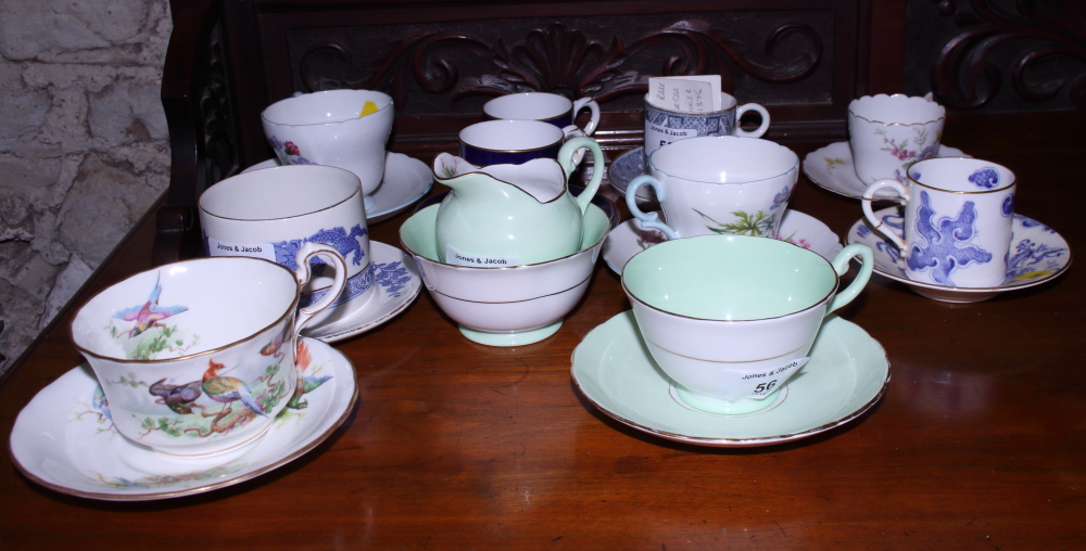 A collection of various English porcelain coffee cans and saucers, including Royal Worcester "Blue