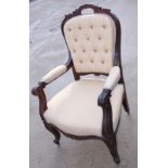 A Victorian carved walnut showframe open armchair, button upholstered in a cream brocade, on