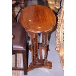 A nest of four occasional mahogany tables, on turned spindle supports