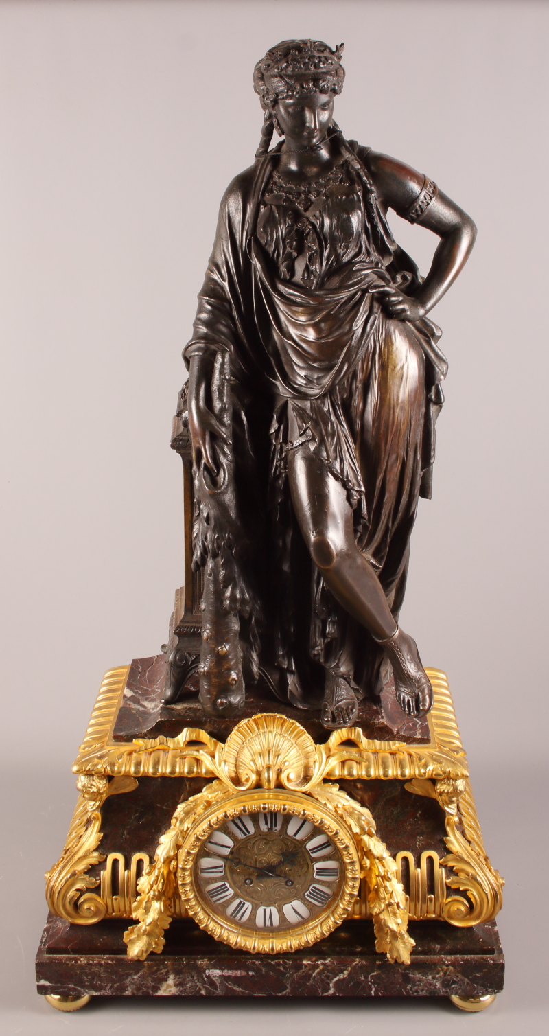 A late 19th century bronze and ormolu mounted mantel clock with classical figure surmount, woman