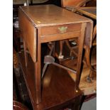 A Georgian mahogany flap top breakfast table, fitted one drawer, on chamfered supports united by